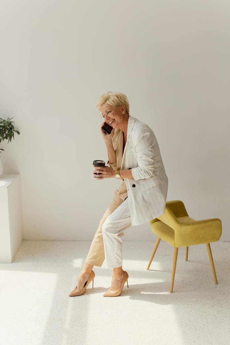 A Businesswoman Talking on the Phone while Sitting on a Chair